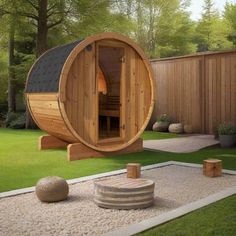 a wooden barrel sauna in the middle of a yard