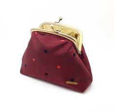 This purse is made from a burgundy red fabric with a small black and red square pattern across the purse. The lining is a gold silk for added luxury every time you open the purse and includes four credit card pockets. Inside you'll find a gold framed kiss lock coin purse in the same fabrics as the larger purse. Both sides of the purse have the same pattern. The purse is interlined with a thick bonded interfacing which feels sturdy but soft & plush in your hand. This is a generous sized purse to Red Square, Irish Gifts, Gold Silk, Square Pattern, Red Fabric, Burgundy Red, Small Bag, Clutch Wallet, Gift For Women