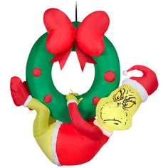 an inflatable christmas wreath with a dr seusster character hanging from it