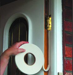 a person holding a roll of tape near a door