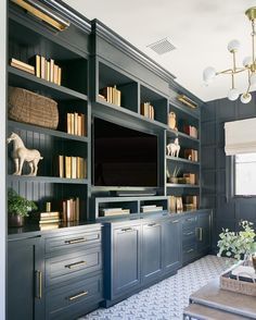 a living room with built in bookshelves and a television