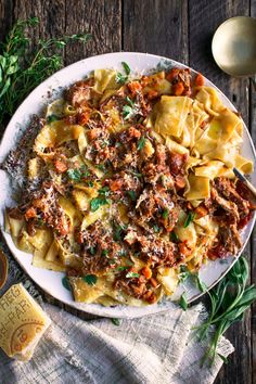 a white plate topped with pasta and meat