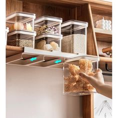 a person is reaching for food in a refrigerator drawer that has bins on it