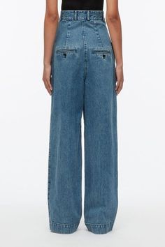 This fashion forward style is cut with stone and enzyme washed denim. With an exaggerated high waist, it elongates the silhouette and accentuates the waist. Wear with a cropped top. 100% Cotton Tailored full length Professional dry clean only Model is 5'10', Bust: 30', Waist: 23', Hips: 34' and wearing a size 4 Dark Wash Cropped Bottoms With Five Pockets, Cropped Denim Workwear Bottoms, Modern Cropped Bottoms With Relaxed Fit, Relaxed Fit Cropped Bottoms In Dark Wash, Denim Blue Relaxed Fit Cropped Bottoms, Relaxed Fit Cropped Denim Blue Bottoms, Denim Blue Cropped Bottoms With Relaxed Fit, Relaxed Fit Cropped Bottoms In Denim Blue, Cropped Denim Flare Jeans With Pockets