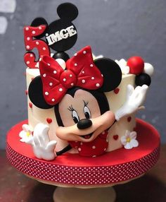 a minnie mouse cake with red and white polka dots