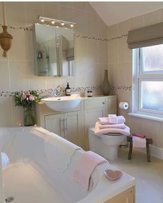 a bath room with a tub a sink and a mirror