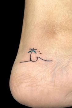 a small palm tree tattoo on the ankle