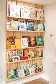 a bookshelf filled with lots of books in a room