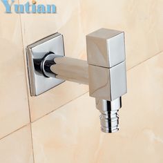 a close up of a wall mounted faucet in a tiled bathroom with the word yutian on it