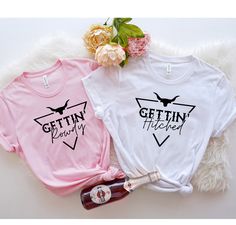 two t - shirts with the words getting married and getting married printed on them next to a bottle of booze