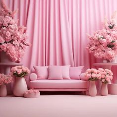 a pink living room with flowers on the couch and vases in front of it