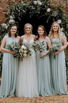 the bride and her bridesmaids pose for a photo