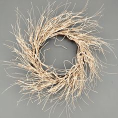 a dried twig wreath on a gray background