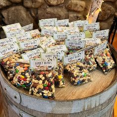 a barrel filled with lots of different types of candy