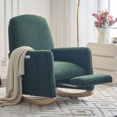 a living room with a green chair and rug