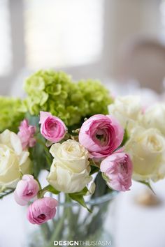 a vase filled with white and pink flowers