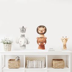 there are three stuffed animals on the shelf next to each other in front of a white wall