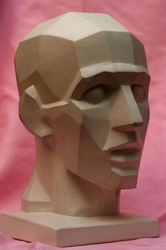 a paper sculpture of a man's head is shown