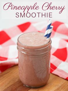 a smoothie in a mason jar with a blue and white striped straw