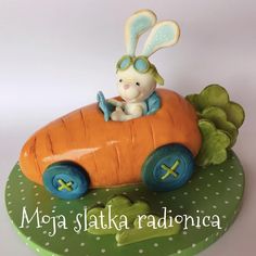 a cake shaped like a rabbit driving a carrot car