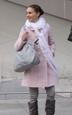 a woman walking down the street carrying a bag