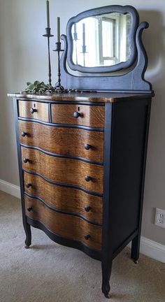 an old dresser with a mirror on top