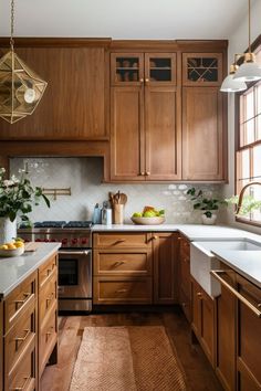 a kitchen with wooden cabinets and white counter tops, along with an area rug on the floor