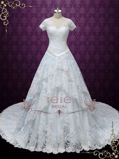 a white wedding dress on display in front of a purple background