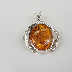 Elegant orange Amber pendant. Handmade of genuine Baltic Amber and sterling silver 925. With stamping. Weight: 8.01 gr Stone size 5 x 2.5 cm Please see more items and you find matching silver earrings. This item was made of natural Baltic Amber. All the amber used in my jewelry is collected in my home country Lithuania. I sell only genuine, real, not pressed, authentic, natural Baltic Amber. Item may have natural imperfections. Classic Orange Jewelry As Gift, Classic Orange Jewelry For Gift, Classic Orange Necklace For Gift, Classic Orange Necklace For Gifts, Orange Polished Finish Jewelry For Gift, Orange Oval Sterling Silver Jewelry, Orange Sterling Silver Jewelry For Anniversary, Sterling Silver Pendant Necklace In Orange, Orange Oval Sterling Silver Necklace