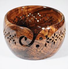 a wooden bowl with an intricate design on it