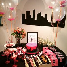 a table topped with lots of desserts and balloons next to a cake on top of a table