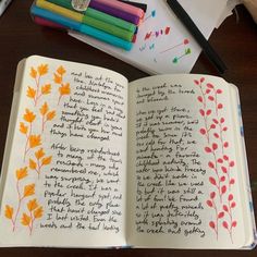 an open notebook with writing on it next to colored markers and crayon pens