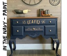 an old dresser painted blue and gold with the words cafe 66 written on it next to a clock