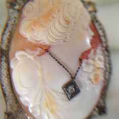 "14K white gold large cameo. Very ornate filigree setting holds a wonderful carved cameo of a beautiful Victorian women from the Edwardian era. This cameo can be both a brooch or a pendant. Brooch was made in the early 1900's and measures slightly over 1 1/2\" in length X approximately 1 1/4\" in width. The necklace she is wearing is a mine cut diamond approximately .10 points. What makes this cameo so special is the fine detailed carving and wonderful frame. The frame has a slight dent see phot Victorian Cameo Jewelry For Formal Occasions, Elegant Cameo Medallion Jewelry, Ornate Cameo Jewelry For Formal Occasions, Formal White Gold Cameo Jewelry, White Gold Cameo Jewelry Gift, Elegant Evening Jewelry With Cameo Detail, Heirloom Cameo Necklaces For Wedding, Wedding Sterling Silver Cameo Jewelry, Elegant Evening Cameo Necklace