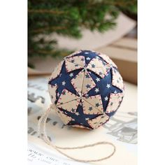 an ornament with red, white and blue stars is sitting on a table