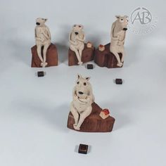 six small figurines of dogs sitting on rocks