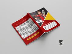 a red and yellow brochure is open on the table