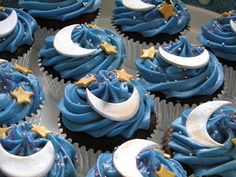 cupcakes decorated with blue frosting and gold stars, moon and crescent decorations