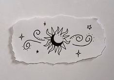 a piece of paper with the sun and moon drawn on it's back side