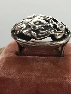 Gorgeous authentic ART NOUVEAU dome ring fashioned after the works of Alphonse Mucha. The ring features a beautiful woman with flowing hair surrounded by flowers and sinuous vines. The ring is heavy weighing 14.175 grams of silver. It is marked STERLING on the outside of the band. I did polish it a little because it was completely tarnished when I bought it but still retains much of the original patina. A great piece to wear or add to any vintage or antique jewelry collection. It is a woman's Si Vintage Adjustable Rings With Unique Design, Antique Handmade Silver Rings, Art Nouveau Engraved Ring Jewelry, Artistic Engraved Formal Jewelry, Antique Handmade Rings In Antique Silver, Artistic Engraved Jewelry For Wedding, Art Nouveau Engraved Ring, Ornate Handmade Collectible Rings, Artistic Hallmarked Jewelry For Formal Occasions