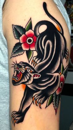 a man with a tattoo on his arm that has a lion and flowers on it