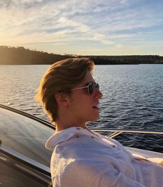 a woman sitting on top of a boat in the water