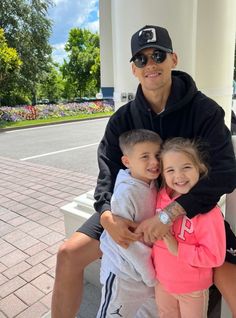 a man and two children sitting on a bench