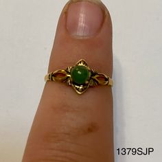 Smaller gold colored ring with small round jade colored stone. Vintage ring inventory form my great grandmother's restaurant and gift shop in Silverton, CO that she owned and operated from the 1960s to 1996. Style 1379SJP Sizes available: Size 4 - qty 2 Size 4.5 - qty 4 Size 5 - qty 5 Antique Gold Round Emerald Ring, Gold Emerald Ring With Round Stone, Vintage Green Opal Ring, Vintage Gold Opal Promise Ring, Gold Vintage Opal Promise Ring, Vintage Gold Jewelry With Round Stone, Vintage Green Opal Ring For Anniversary, Vintage Green Opal Round Ring, Vintage Gold Rings With Round Stone