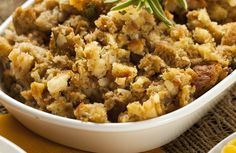 a white bowl filled with stuffing on top of a table