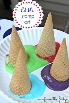 three ice cream cones sitting on top of each other in front of a paper plate