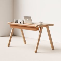 a laptop computer sitting on top of a wooden desk