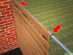 a brick wall with red arrows pointing to the left and right side of the fence