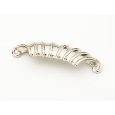 a silver plated brooch or pin with wavy lines on the side and curved ends