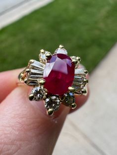 18K Gold Size 7.50 Total Weight (grams): 4.60 Primary Stone: Ruby Primary Stone Shape: Oval Faceted Primary Stone Dimensions: 7.10 x 5.10 mm Total Primary Stone Carat Weight: 1.12 ct Secondary Stone(s) Type: Diamond Secondary Stone(s) Shape: Round Brilliant Cut, Baguette Cut Secondary Stones Dimensions: 2.60 - 2.75 x 1.50 mm - approximate Total Secondary Stones Carat Weight: 0.74 ctw Secondary Stone Color Grade: J - K Secondary Stone Clarity Grade: VS1 - VS2 *Please note any spots that appear to be chips in the photos are just reflections of the light on the stone from the gold prong settings. The stone is in excellent condition*  This ring has been evaluated and verified by a GIA Graduate Gemologist Classic Yellow Gold Ruby Ring Gia Certified, Classic Yellow Gold Gia Certified Ruby Ring, Fine Jewelry Gold Ruby Ring Gia Certified, Gia Certified Ruby Jewelry With Baguette Cut, Anniversary Yellow Gold Gia Certified Ruby Ring, Gia Certified Yellow Gold Ruby Ring For Anniversary, Gia Certified Baguette Cut Ruby Jewelry, Gia Certified 14k Gold Ruby Ring, Gia Certified Yellow Gold Ruby Ring With Round Cut